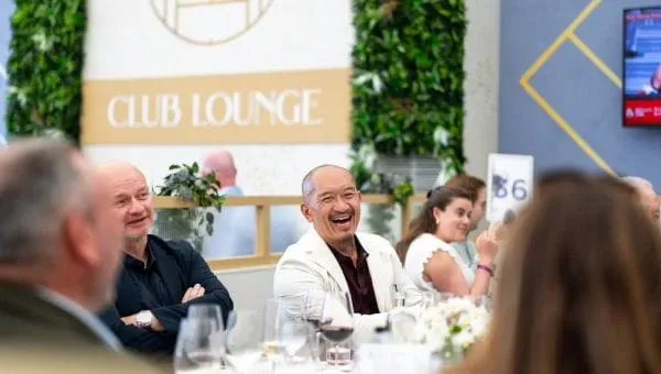 Live music, a private outdoor garden overlooking the practice courts, and a five-course tasting menu with a rosé Champagne reception. The most intimate mid-tier option at Queen's.